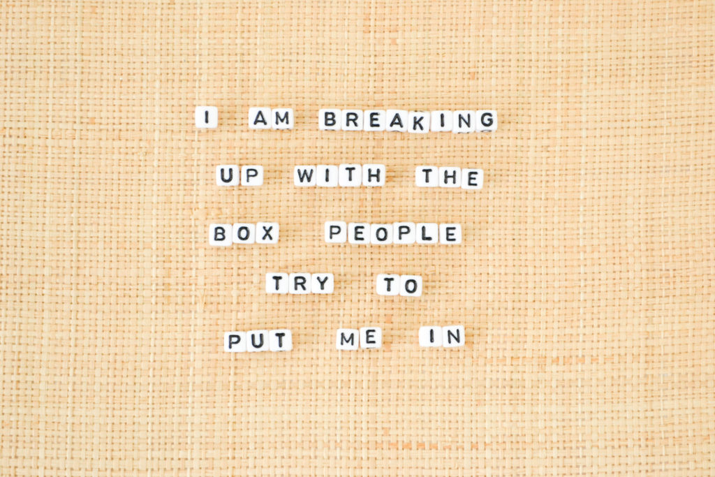 small tile letters that spell out "I am breaking up with the box people try to put me in"